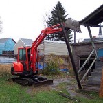 The side porch and its accompanying roof came off first to give the excavator some room to work.