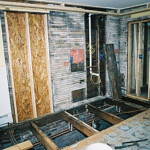 We removed the subfloor and adjusted the underlying joists as much as possible to level things out.