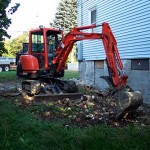 Spreading the pile of old chimney bricks that will eventually be buried.
