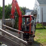 Getting instruction on how to use the bucket for demolition.