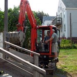 Getting instruction on how to use the bucket for demolition.