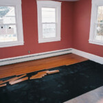 Putting down red oak flooring in the dining room.