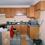 Installing cabinets in the kitchen. See the microwave? Sue moved that in several months ago to heat up lunch. How civilized.